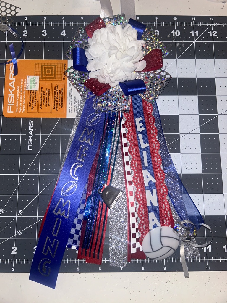 Homecoming garter with ELIANA name and HOMECOMING ribbons