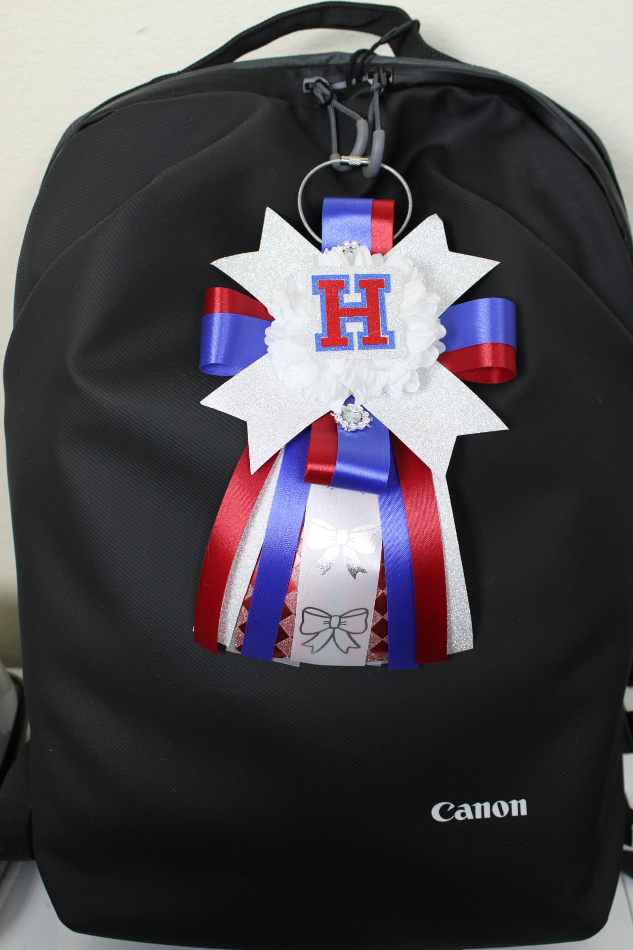 Mini homecoming mum with star backing on a backpack